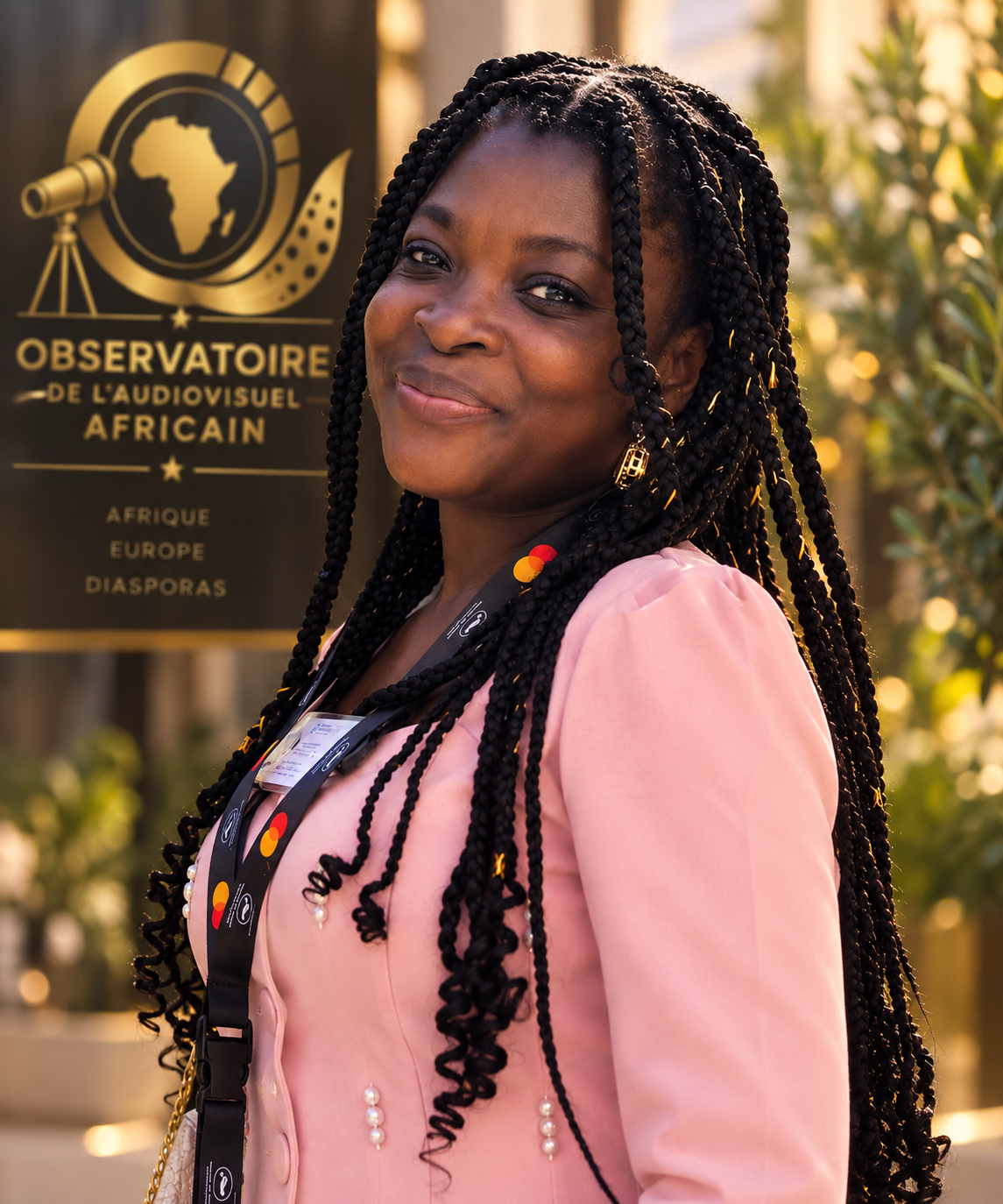 Tzipporah MAYALA devant l'emblème de l'Observatoire de l'Audiovisuel Africain